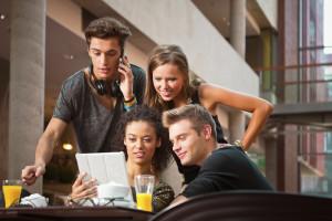 College students looking at laptop 