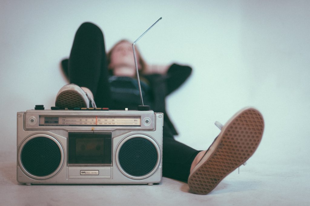 woman listening to a vintage radio