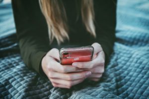 Woman scrolling through social media on her phone