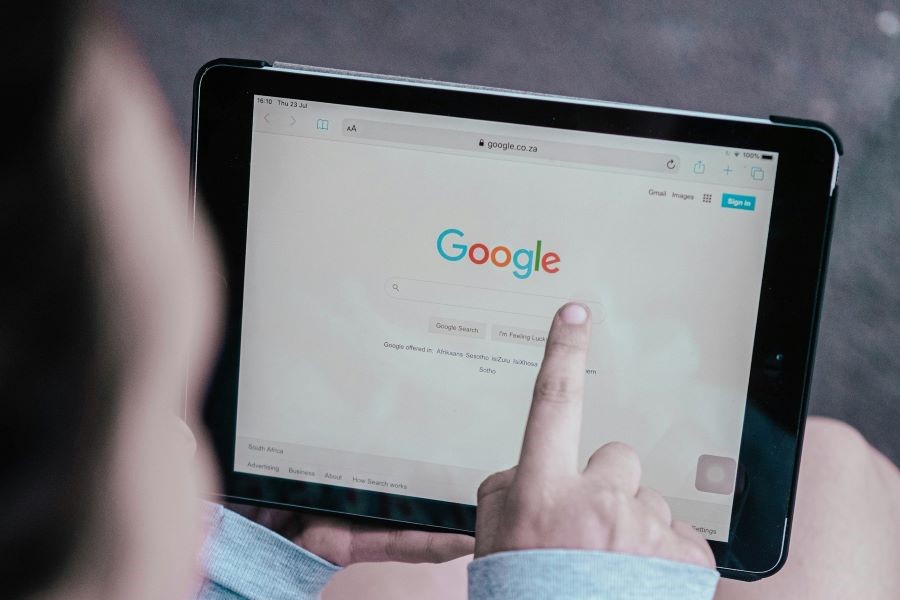 Person searching Google on an iPad