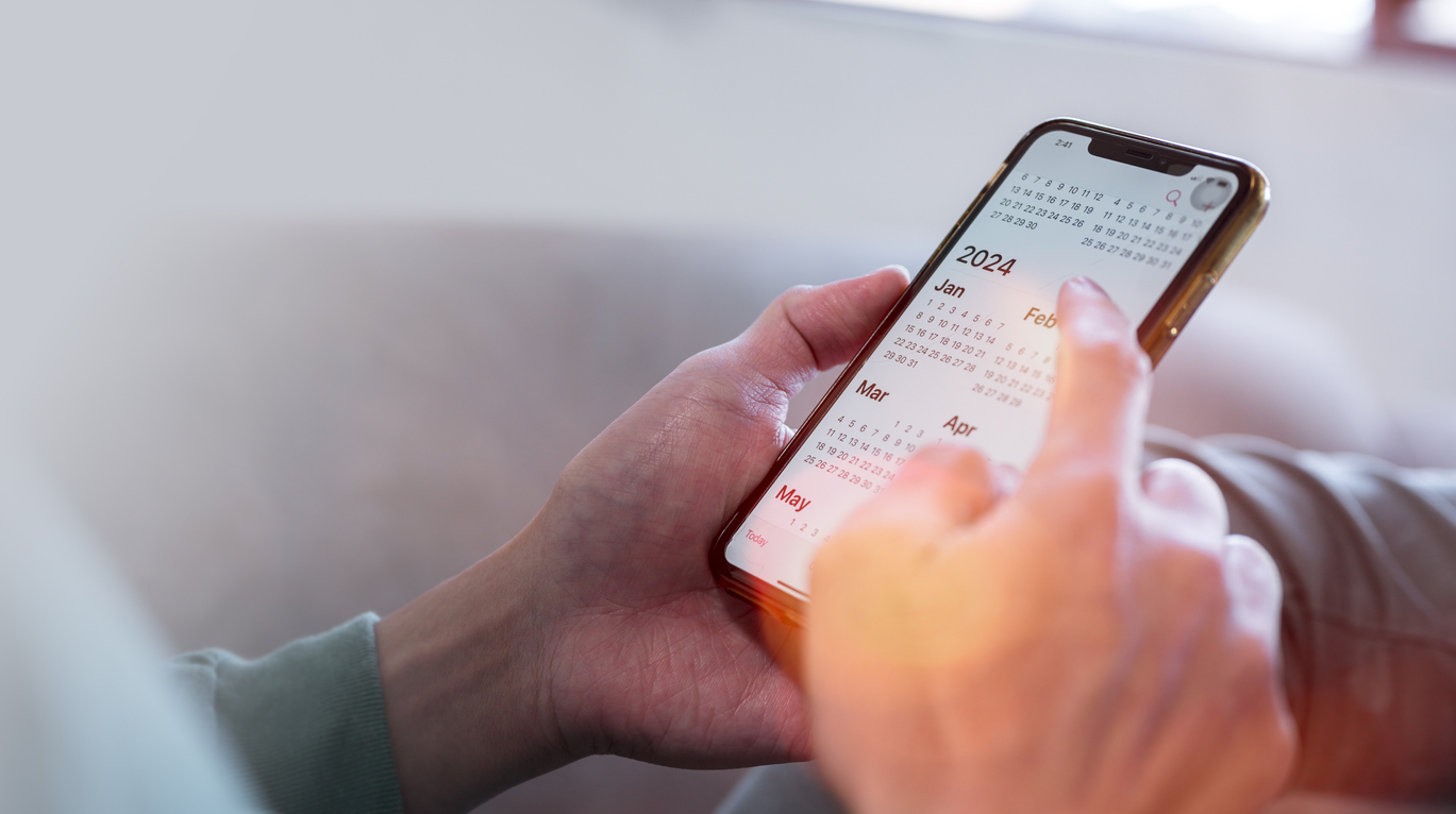 person using cell phone while on couch