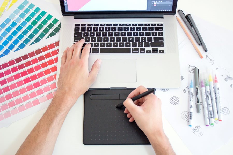 Laptop next to color swatches and pens